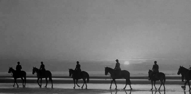 circa 1937: Horse riders on Blackpool beach, silhouetted against the evening sky. (Photo by Fox Photos/Getty Images)