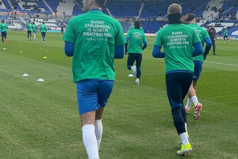 Birmingham City players warming up in their NSPCC green t-shirts