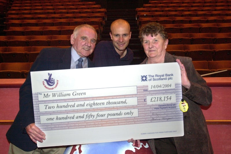 Lottery winners William and Brenda Green receive their cheque for £218,154 from snooker player Andy Hicks during the World Snooker Championships at the Crucible Theatre, Sheffield, in April 2004 