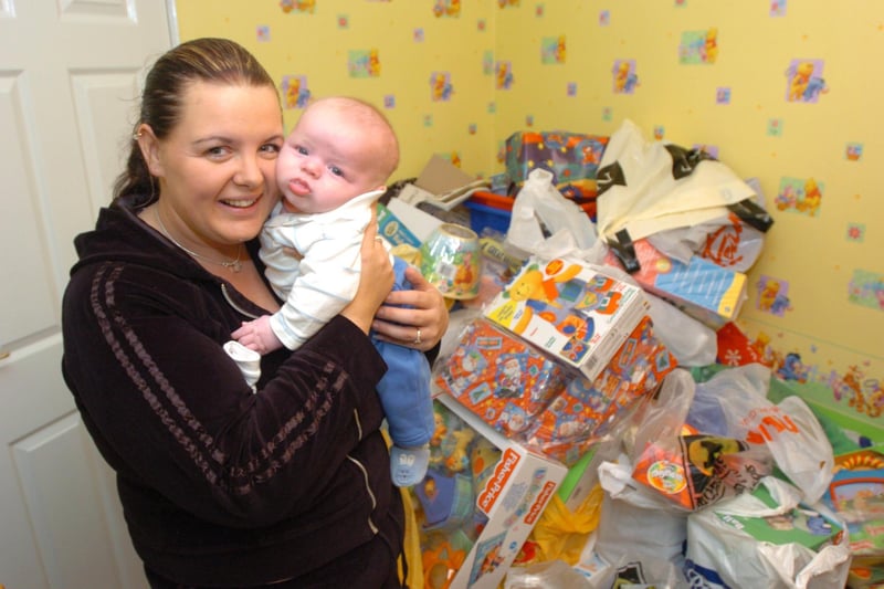 Lottery winner Trish Emson and baby Benjamin of Elliot Close, Wath, in Benjamin's room stuffed full of presents. Trish won £1.7 million in October 2003 but vowed to keep her feet on the ground - in 2015 she was working as a dinner lady in Benjamin's school
