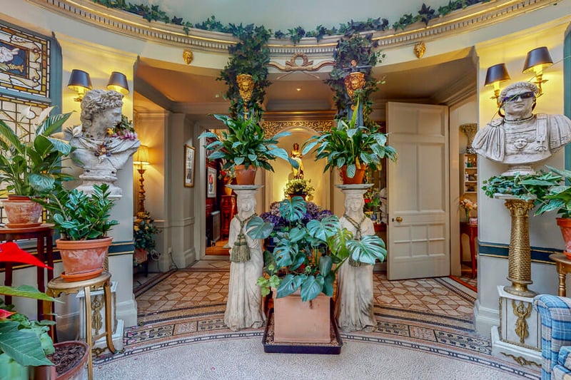 A look inside the beautiful and unique rotunda garden room with mosaic tiles and original stained-glass windows. 