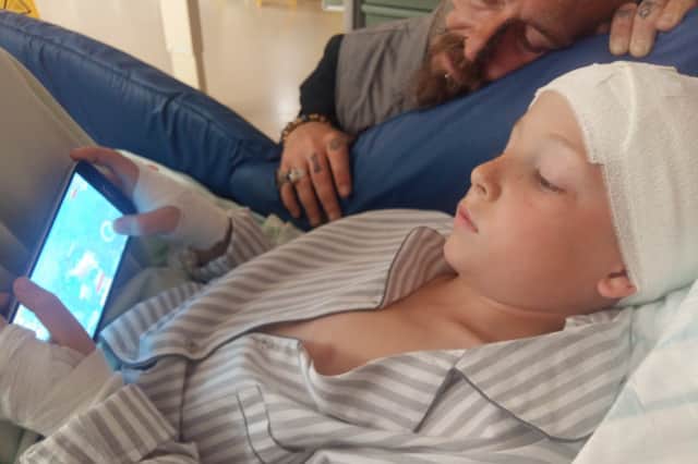 Vincent pictured in hospital following the accident in 2018 with his dad, Jim. 