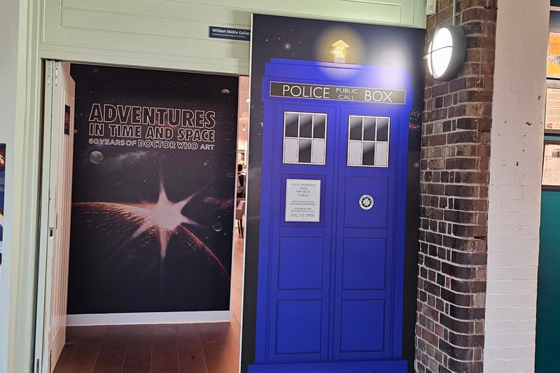 The entrance encourages visitors to “hop onto” the Tardis to adventure through time and space through the art exhibition.
