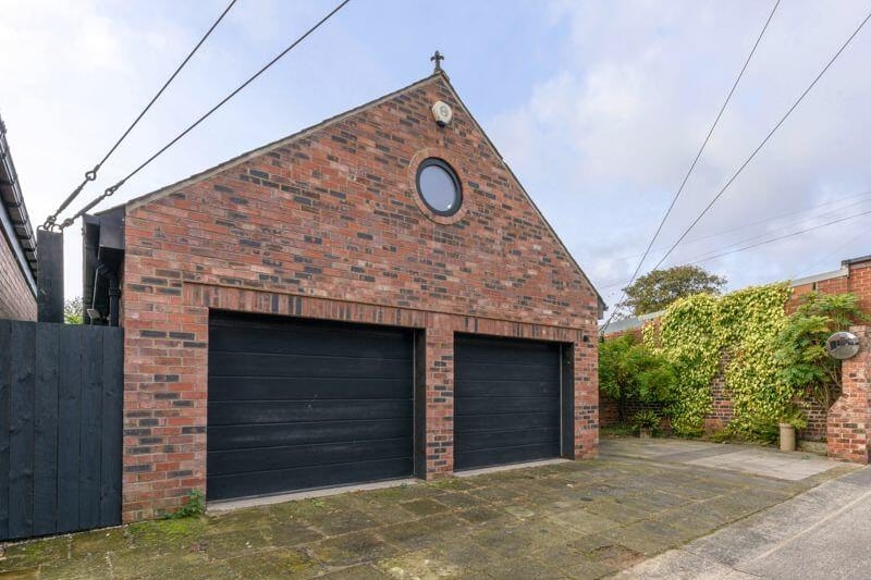 Separated from the main house by the rear access lane is an adjacent coach house, which incorporates a double garage and a double parking space.
