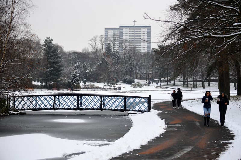 Members of the public walk in the snow in Victoria Park in Glasgow in December 2023. 
