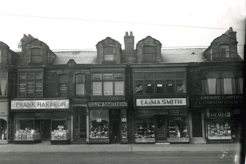 Lytham Road shops close to the junction with Waterloo Road. The Lido was further along on the left.
According to the plaque this terrace of shops was built in 1892. Seen here in the 1950s the shops include from the left Greenhalgh's ladieswear, Frank Harbron grocers, J.W. Smith  menswear, E.A. & M.A. Smith bakery and cafe and J.L.Dawson Cook dispensing chemist and opticians
