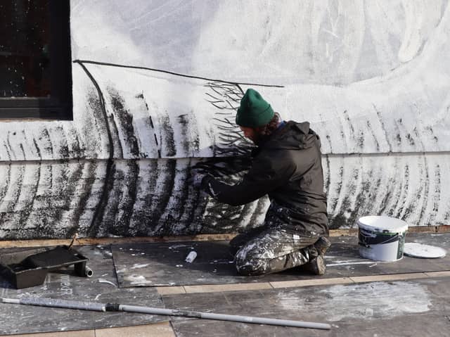 The artist Phlegm, working on his mural on the side of the Eyewitness Works, in Headford Street, Broomhall, Sheffield.  Picture: Capital&Centric