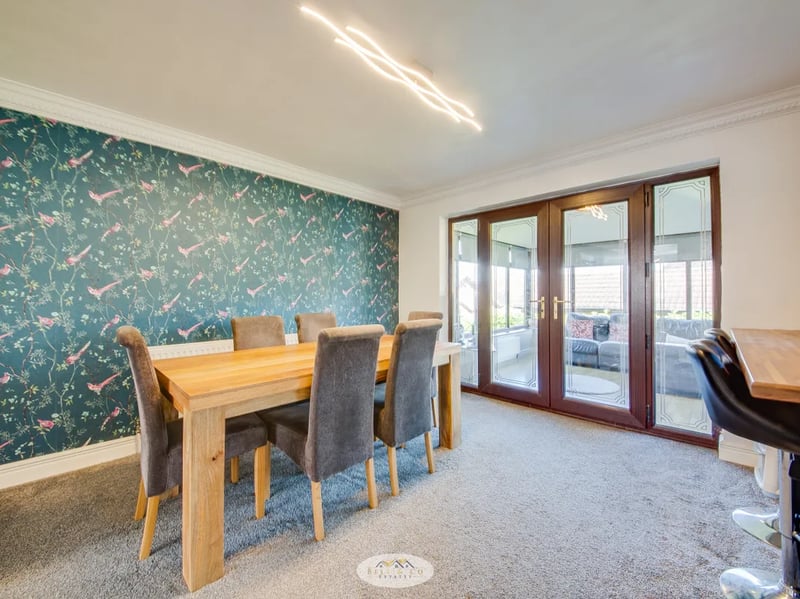 Separated from the kitchen by the two seater breakfast bar, this dining room offers access to the conservatory. (Photo courtesy of Zoopla)