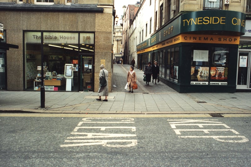 A view of High Friars Lane/Pilgrim Street Newcastle upon Tyne taken in 1995. The photograph has been taken from one side of Pilgrim Street looking across to the other side. 'The Bible House' is in the centre to the left. High Friars Lane which runs to Grey Street is to the right of 'The Bible House'. The Central Exchange Buildings can be seen at the end of High Friars Lane. The Tyneside Cinema is at the junction of Pilgrim Street and High Friars Lane. 