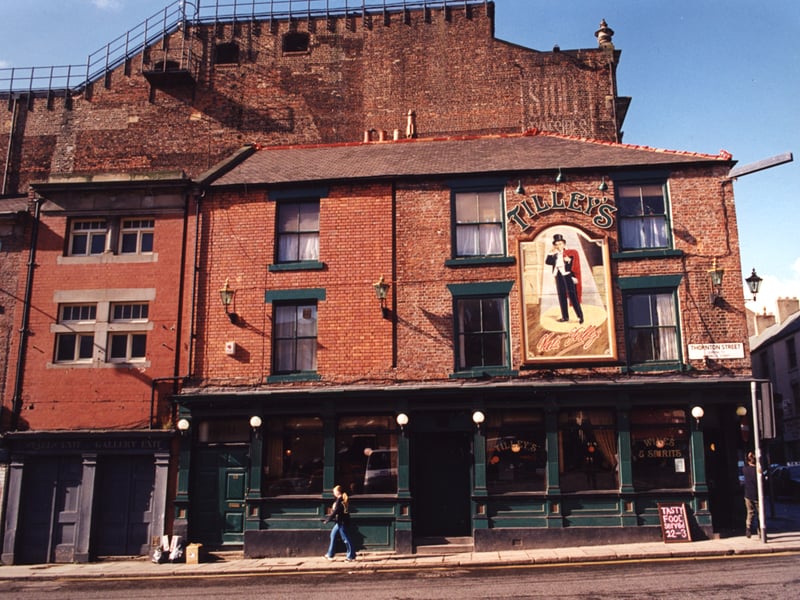 A 1995 photograph of Tilley's restaurant at the junction of Westgate Road and Thornton Street. The view is of the side of Tilley's on Thornton Street. To the left are the exits for the Stalls and Gallery of the Tyne Theatre