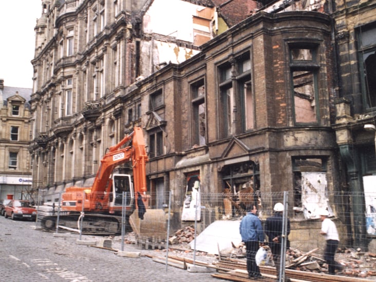 A view of St. John's Street Newcastle upon Tyne taken in 1995. The photograph shows the refurbishment of the side of the Wenger's building on St. John's Street. Buildings on Grainger Street can be seen in the background.