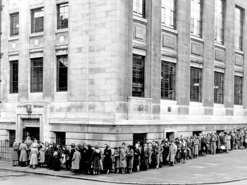 People queue outside Sheffield Central Library, at the junction of Tudor Street and Tudor Place, to see a film on a Saturday afternoon in November 1950