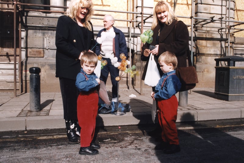  A view of the Quayside Market Newcastle upon Tyne taken in 1995. The photograph shows two women and two children standing in front of a man selling balloon animals
