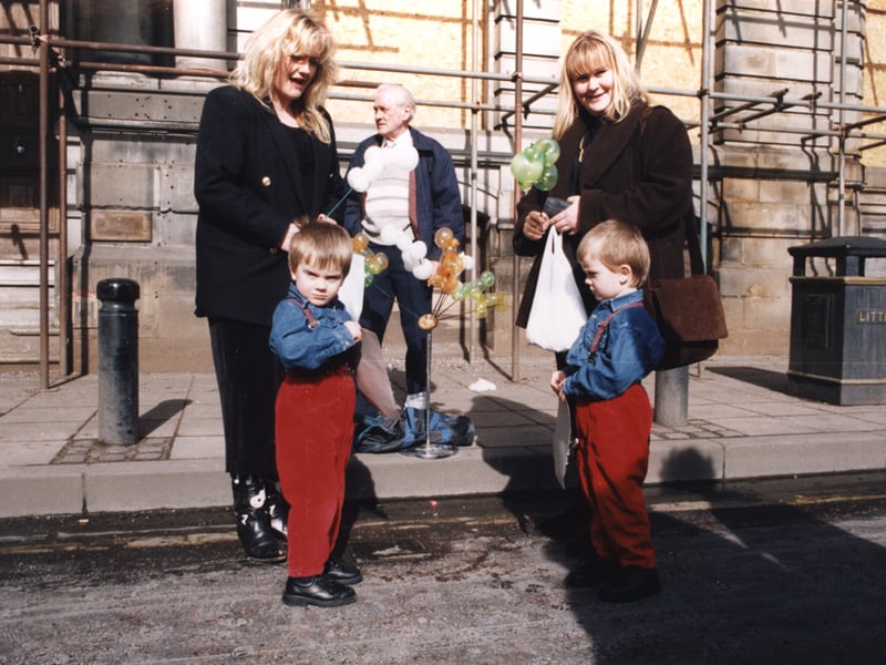  A view of the Quayside Market Newcastle upon Tyne taken in 1995. The photograph shows two women and two children standing in front of a man selling balloon animals