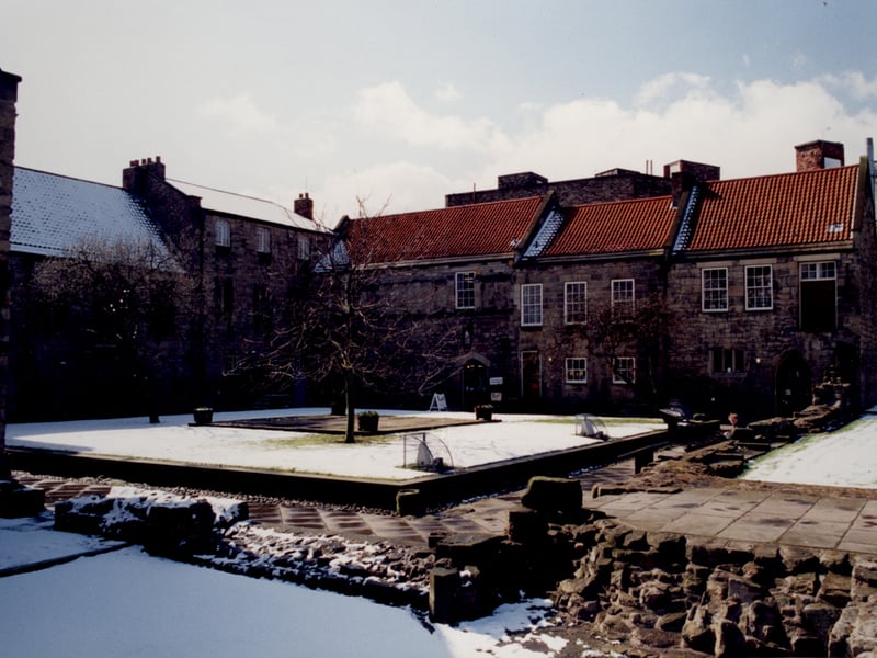 A view of Blackfriars Friary Newcastle upon Tyne taken in 1995. The photograph shows the courtyard surrounded by buildings on three sides. Archaeological remains of the Friary can be seen in the foreground.