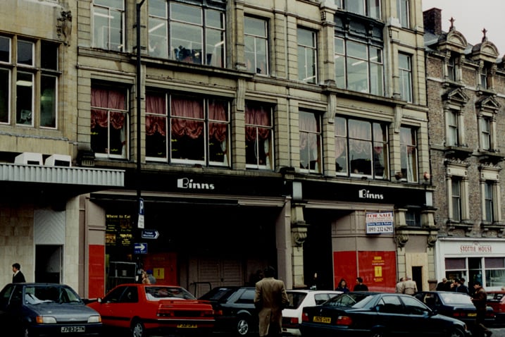 A photograph of the frontage of Binns department store on the Bigg Market Newcastle upon Tyne taken in 1995. The department store is 'For Sale'.