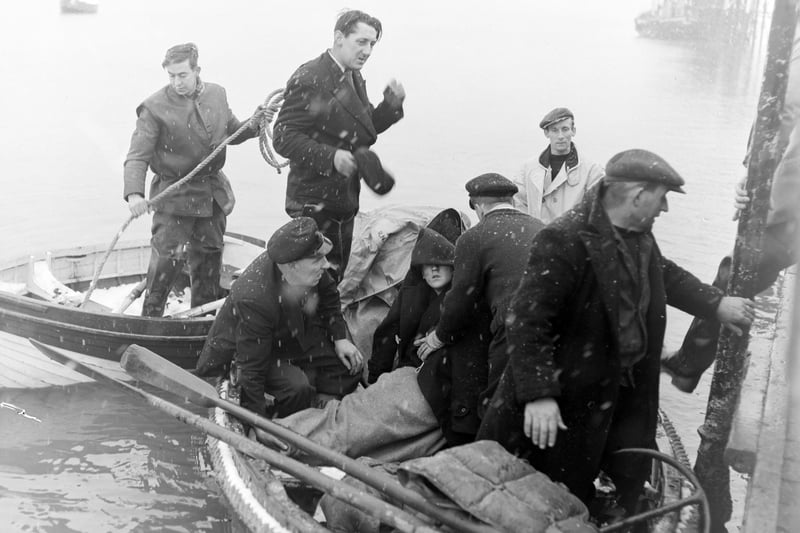 Three Blackpool youths were rescued, near the mouth of the River Ribble by Lytham Lifeboat, after spending the night in a rubber dingy. The three, who were taken to hospital, were named as Richard Walsh (16), James Varey (18) and Bobby Waddington (17). Picture shows the boys huddled together as they were brought ashore at Lytham