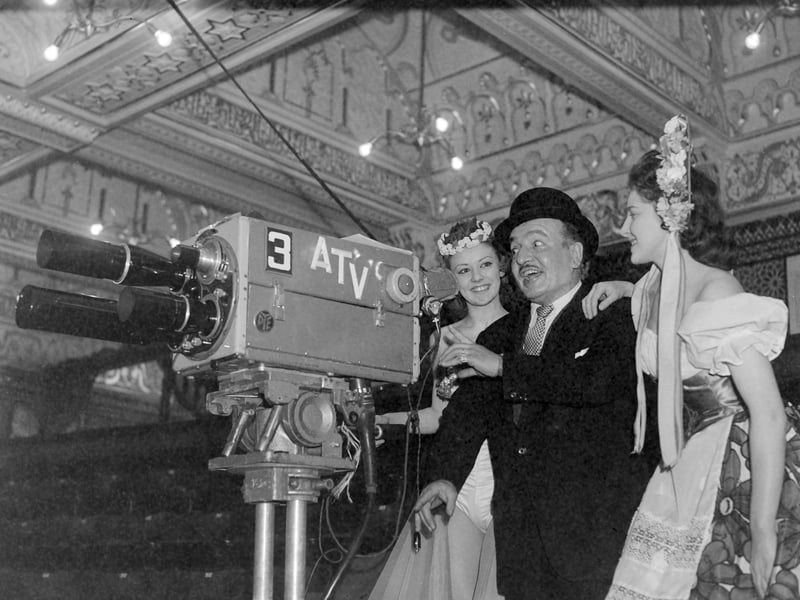 Tower circus clown Charlie Cairoli demonstrates his skill with the camera to Circusettes Sandra Edwards (left) and Valerie Sutton before the ITV broadcast of excerpts from the season show