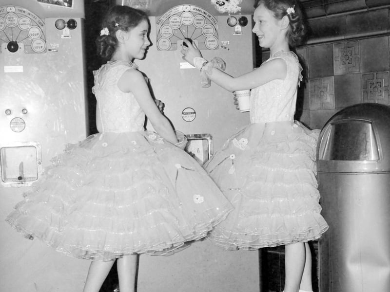 Two thirsty competitors at the Blackpool Dance Festival for Juniors at the Empress Ballroom try out the drinks machine