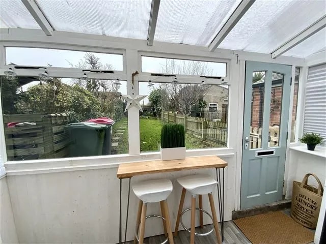 This porch to the rear of the house provides a lovely environment to look out into the garden. (Photo courtesy of Zoopla)