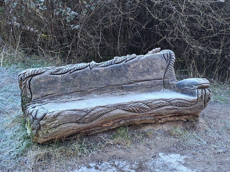 We came across a beautifully sculptured log bench past the orchard, next to the path leading up to the Tump.
