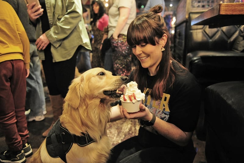 Amelia Raw with her dog Dexter enjoying a snack.