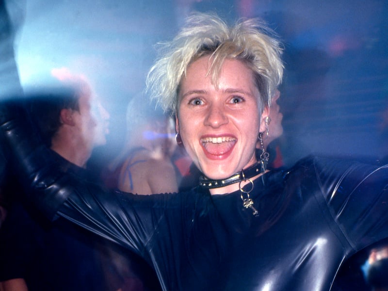 A clubber wearing a rubber suit on the main dancefloor of the Hacienda, 1988.