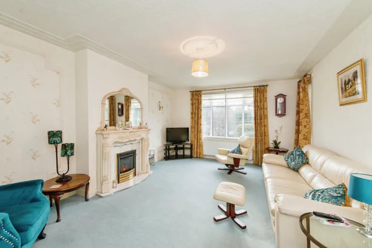 The delightful lounge is a spacious room full of natural light and with a charming fireplace.