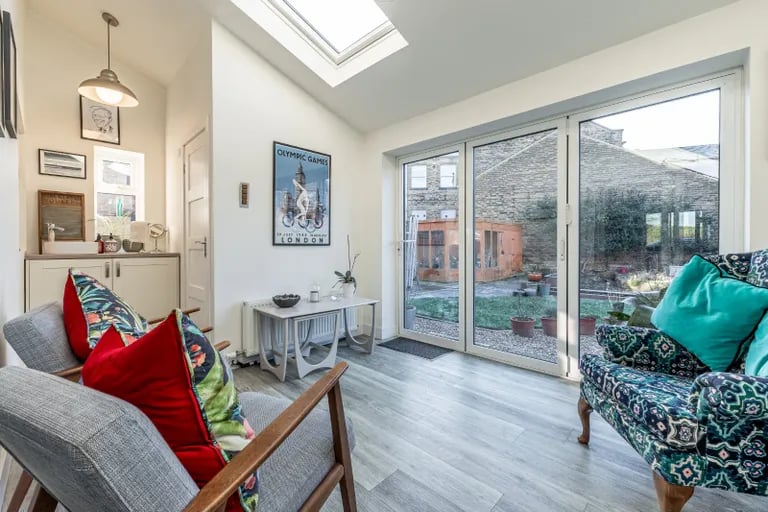 Sliding patio doors in the kitchen lead to the extended family room with pitched roof and two Velux skylights along with bi-folding doors leading out onto the rear garden.