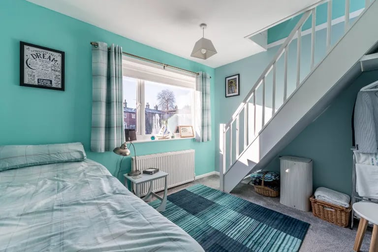 A further double bedroom sits to the rear with stairs to a loft room. 