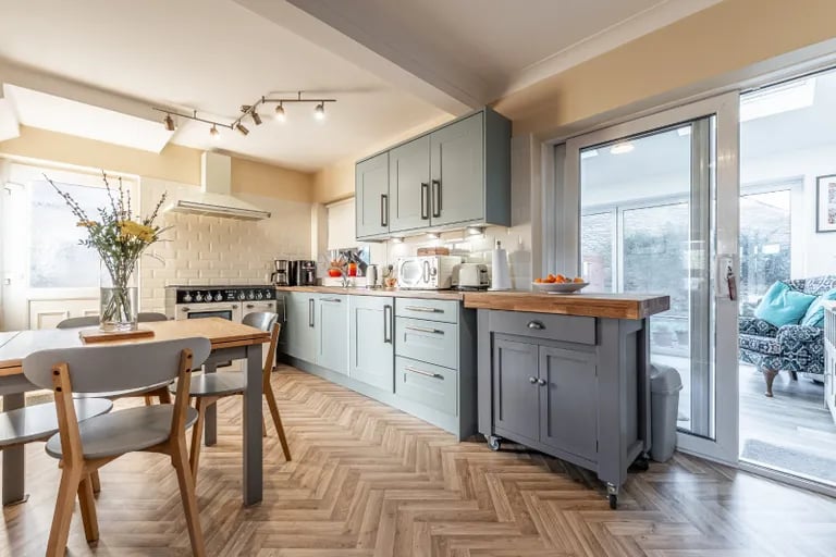 The heart of the home is this open plan dining kitchen recently fitted with a range of base & wall storage units, a Smeg Rangemaster cooker, integrated dishwasher and washing machine.