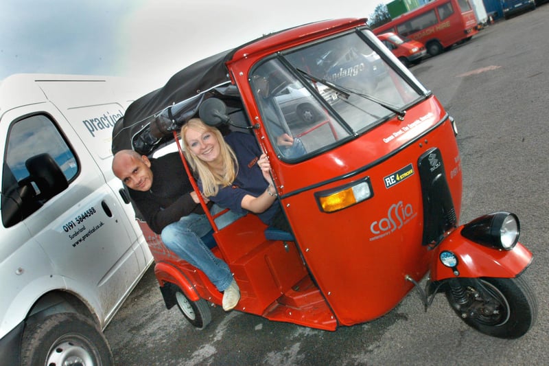 Steve Webb of the Tuk Shop demonstrates his rikshaw to Gemma from Practical Car Rental in Philadelphia in 2005.