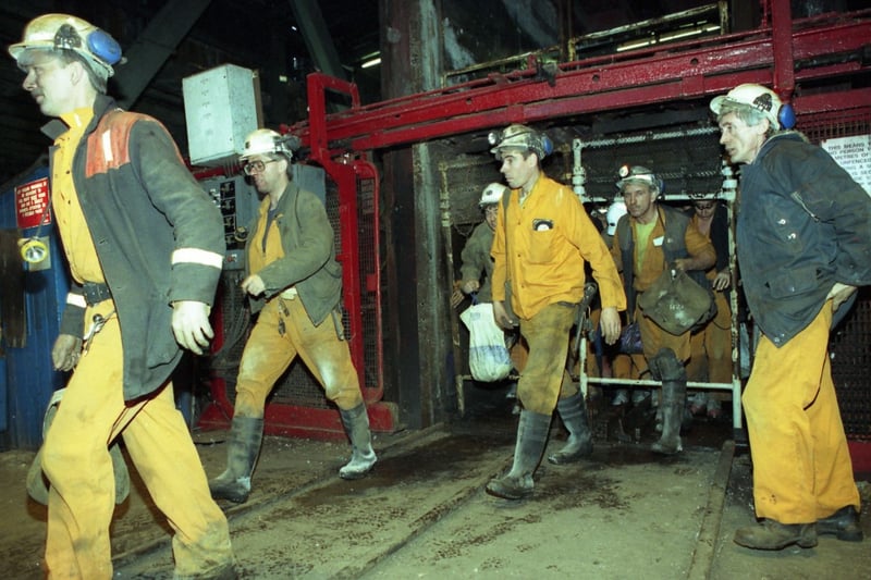 Men in their pit clothes leave the cages at Wearmouth Colliery for the last time in December 1993.