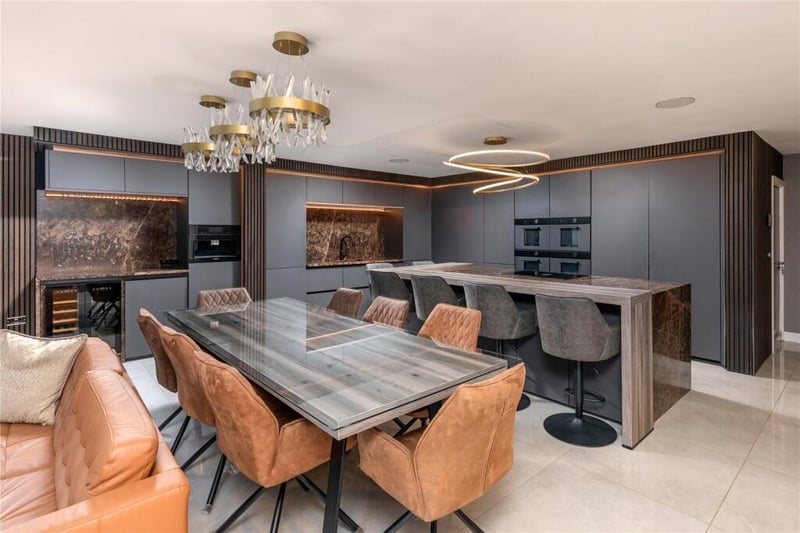 The property listing states that the "innovative kitchen" comes with matte units and a marble breakfast bar, as well as integrated appliances.