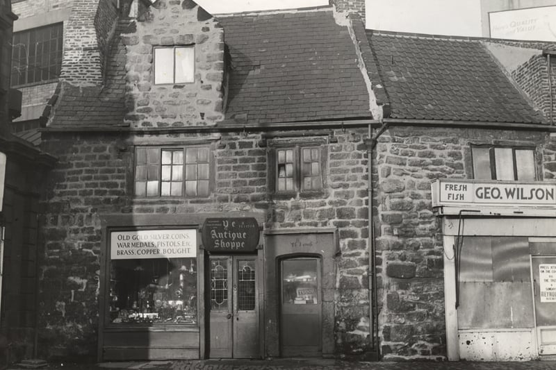  A view of the exterior of 'Ye Antique Shoppe' Percy Street Newcastle upon Tyne taken c.1960. To the right of the entrance to the antique shop there is a second doorway in the building which is dated to '1706'. 'Geo. Wilson' fresh fish shop is to the left of the antique shop