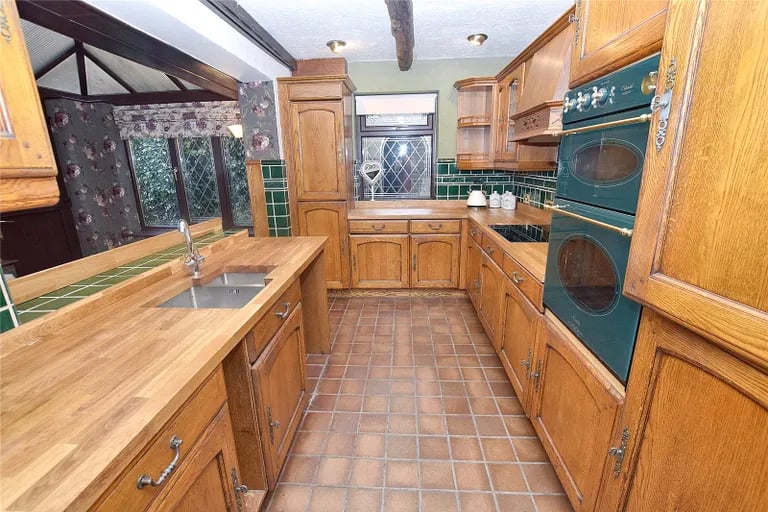 The kitchen area has a good range of wall and base units with electric oven and hob and opens to the breakfast room.