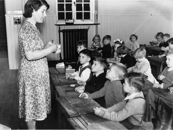 Children at Tollcross Primary School with their class teacher in the 1950s 