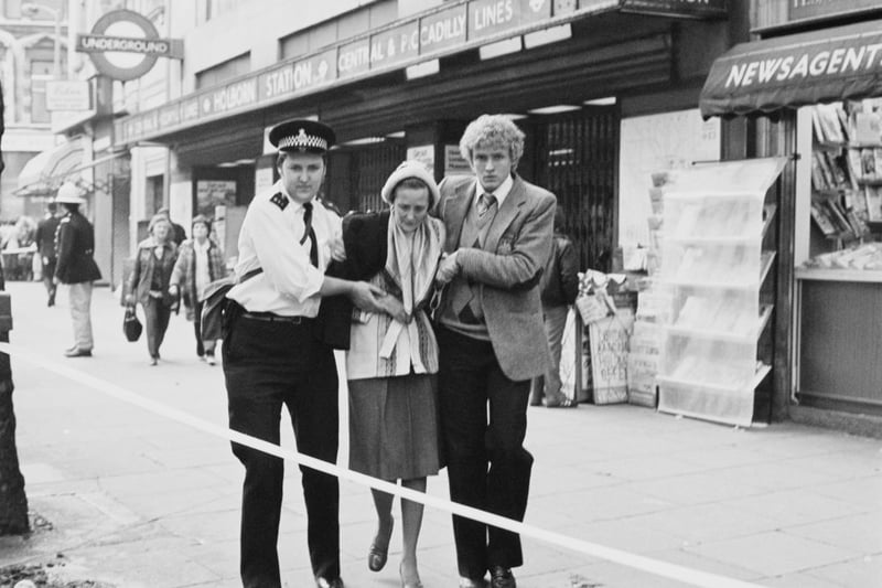A police officer and a young man escort a woman outside Holborn Underground Station following a rail crash occurred on the Central line at Holborn, London, UK, 9th July 1980. (Photo by Aubrey Hart/Evening Standard/Hulton Archive/Getty Images)