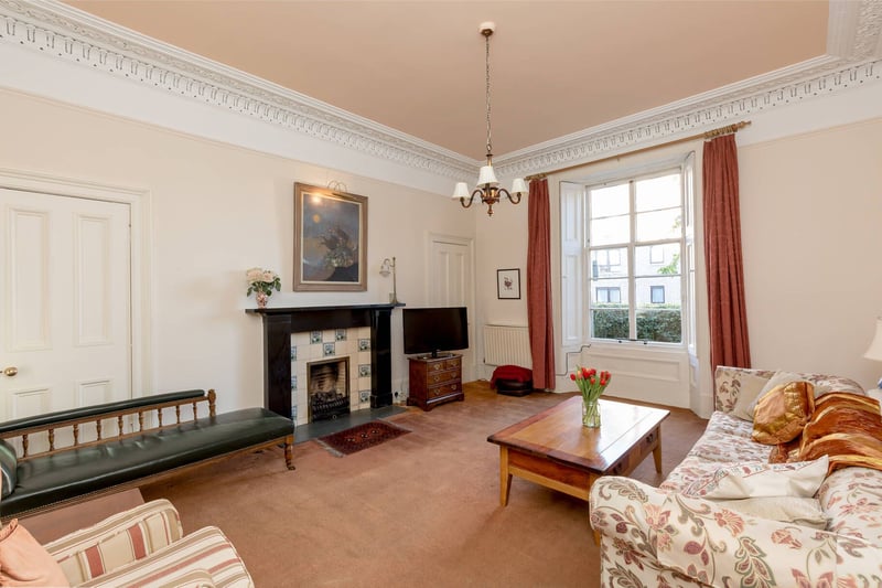 The property's elegant living room with gas fireplace and surround.