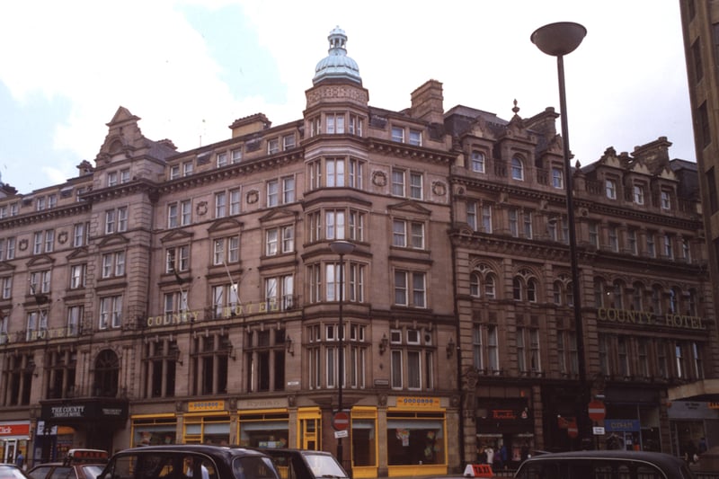A photograph of the Count Hotel in Neville Street and Grainger Street. The view is from the opposite side of Neville Street looking across to the hotel. The hotel is above shops on the two streets.