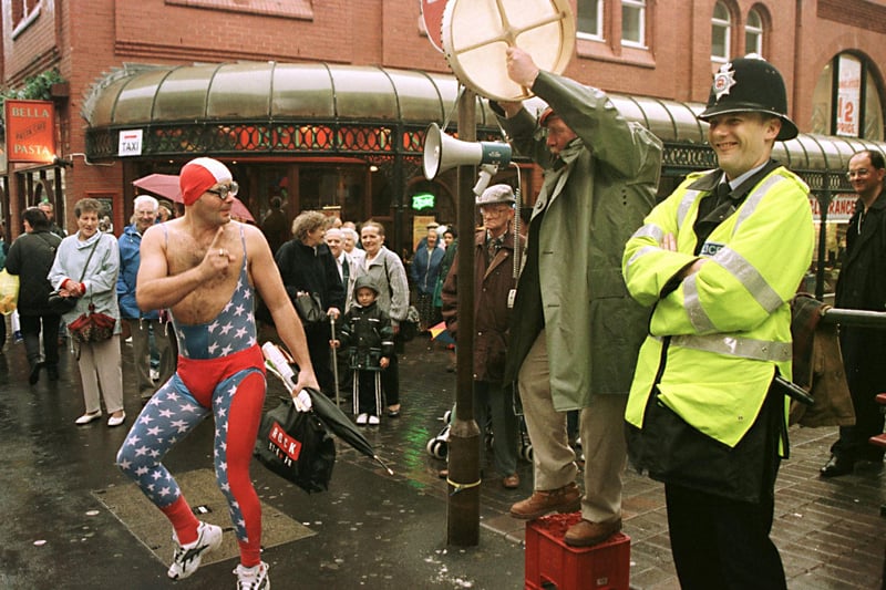 The self-proclaimed leader of the Tommy Sex Party (L) dances to the beat of Harry McEachan, 30 September, protesting on behalf of the New Scottish Socialist Party to the amusement of police outside the Winter Gardens where the week-long Labour Party Conference is being held