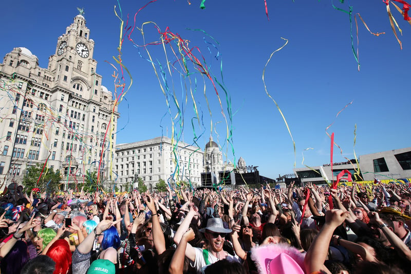 Eurovision fans enjoy the party atmosphere as they gather in Liverpool to watch the Eurovision Song Contest final on a giant screen in the Eurovision Village on May 13, 2023.