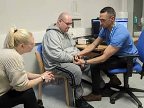 A stroke patient is shown how the new device works as part of the new trial