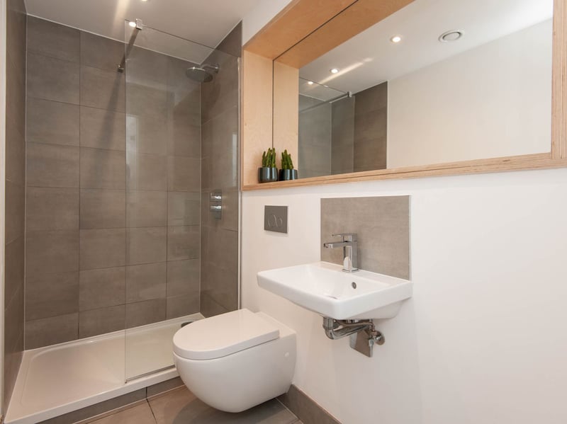 It is a modern en-suite, boasting a lovely, big mirror. (Photo courtesy of Redbrik)