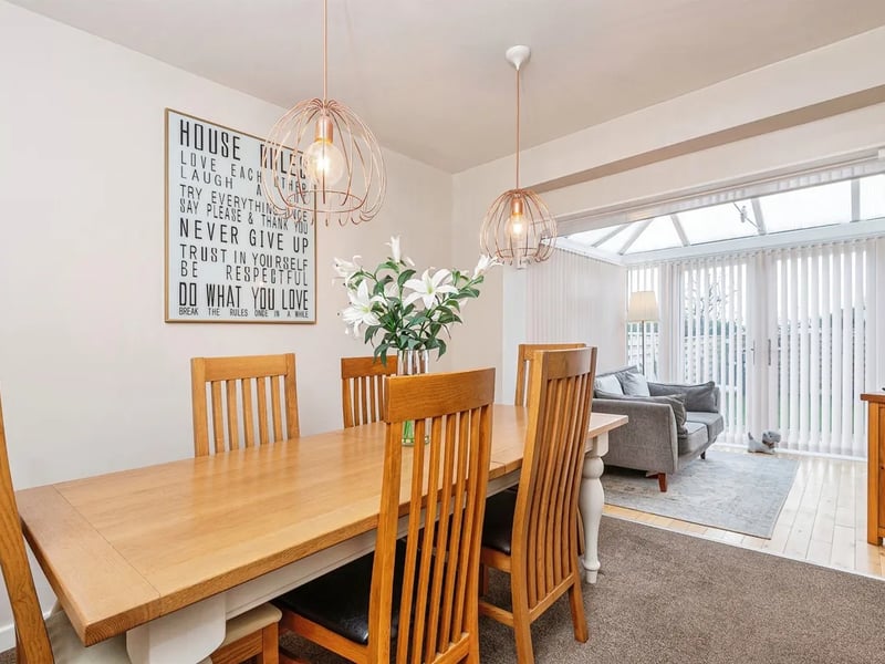 A separate dining room opens to a conservatory.