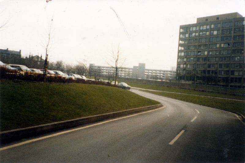 Looking across the Inner Ring Road to buildings of Leeds Polytechnic (now Leeds Metropolitan University) on the right, taken from Vernon Road. A multi-storey car park on New Woodhouse Lane is seen in the centre background, while an outdoor car park is on the left.