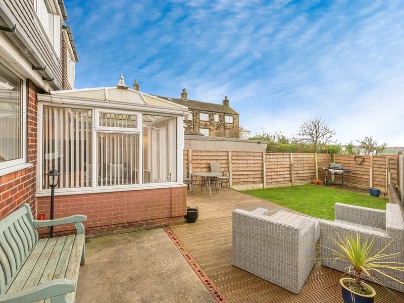 The rear garden features a large patio accessed from the conservatory.