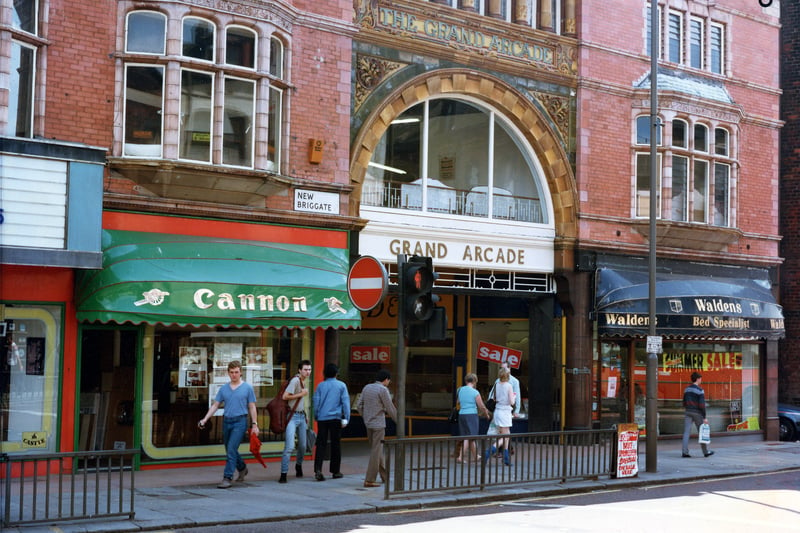 The entrance to the Grand Arcade on New Briggate in July 1985. To the left is Cannon, kitchen and bathroom units, and to the right Waldens bed specialists. On the far left the edge of the Tower Picture House can be seen; this was closed earlier in the year, on March 7, 1985.