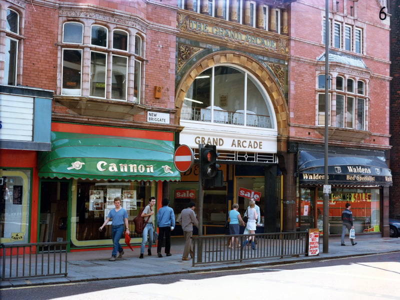 The entrance to the Grand Arcade on New Briggate in July 1985. To the left is Cannon, kitchen and bathroom units, and to the right Waldens bed specialists. On the far left the edge of the Tower Picture House can be seen; this was closed earlier in the year, on March 7, 1985.
