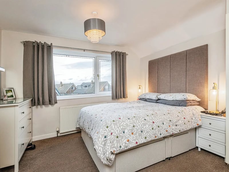 The master bedroom has built-in wardrobes and a window overlooking the front elevation.